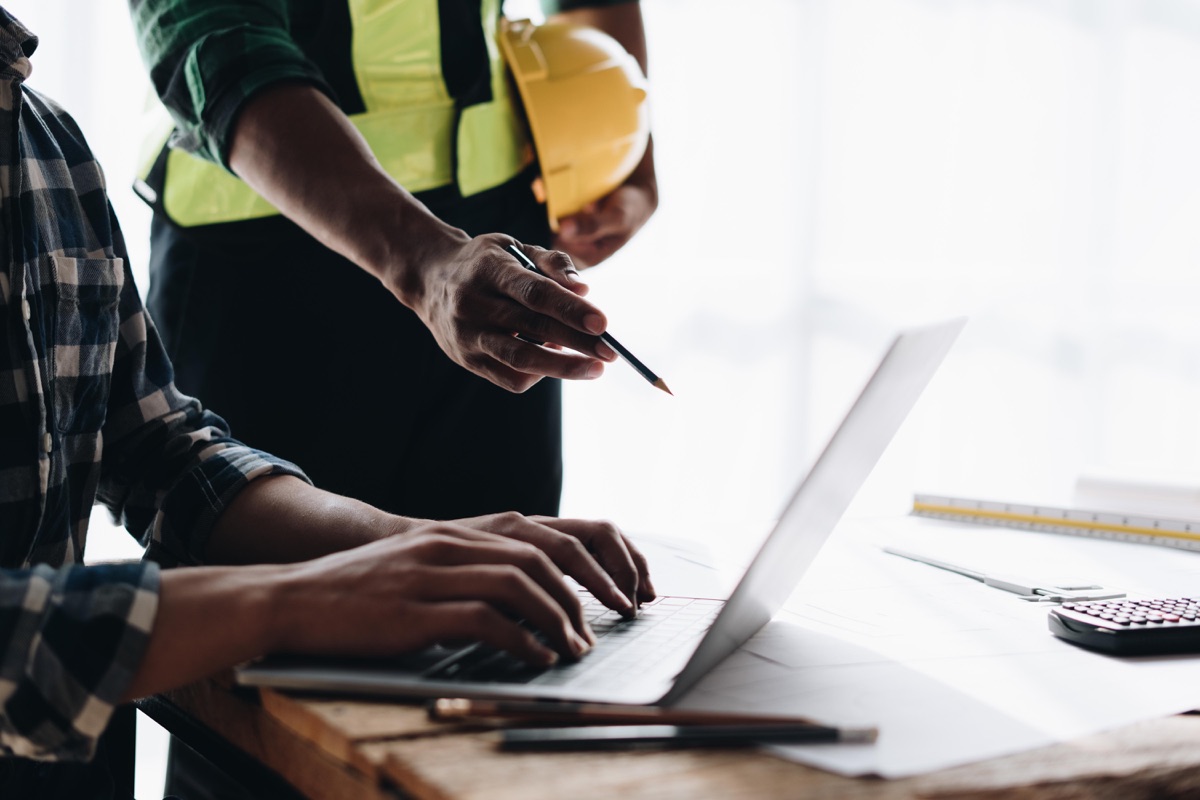 Solar installer reviewing a professional website on a laptop